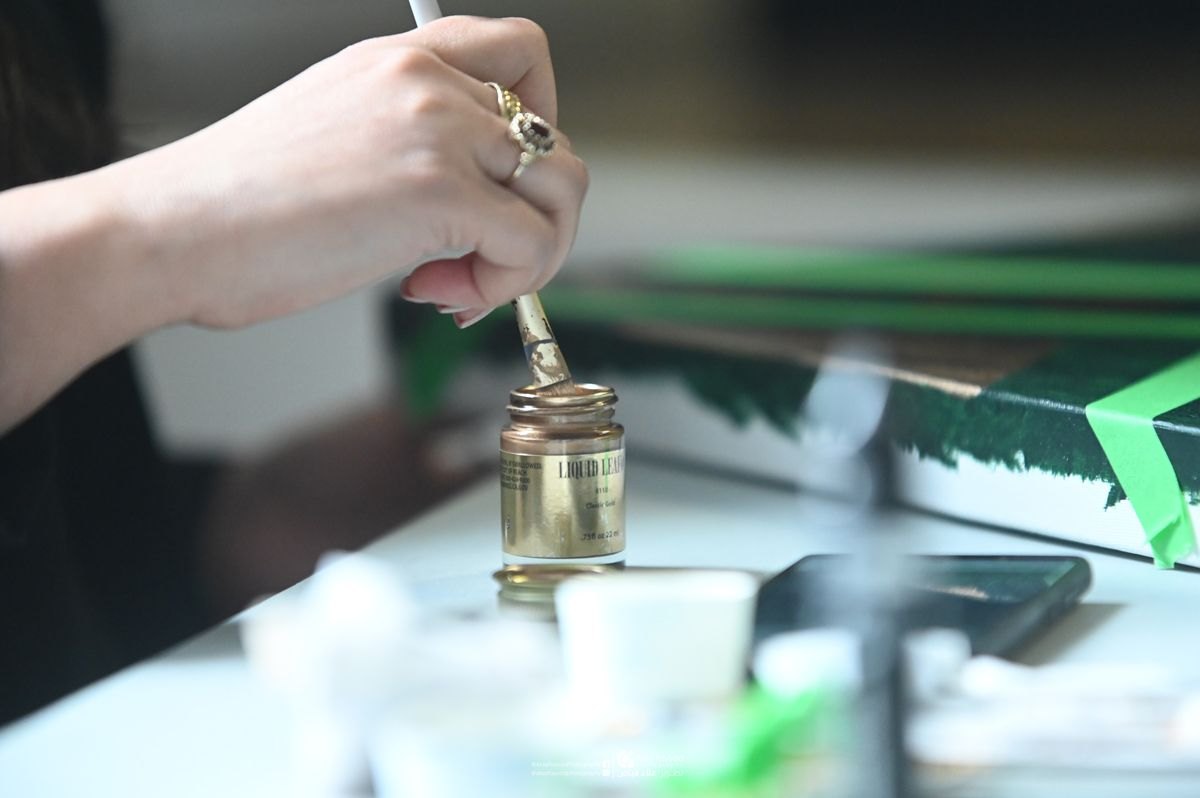 Hand applying liquid gold leaf — Hala Ali studio process