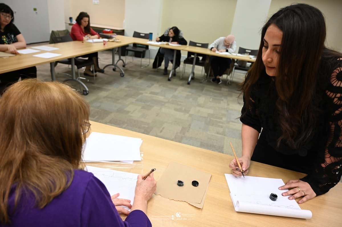 Hala Ali teaching a calligraphy workshop, classroom view
